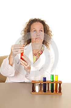 Crazy woman scientist with test tubes frown