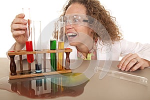 Crazy woman scientist with test tubes grab red