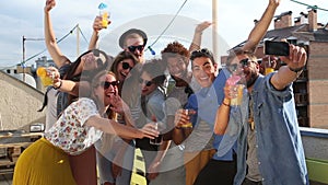 Crazy young friends taking selfie on the rooftop terrace