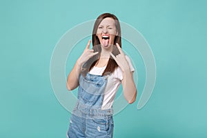 Crazy young woman girl in casual denim clothes isolated on blue turquoise background. People lifestyle concept. Mock up