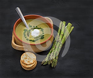 Cream of Asparagus Soup on dark wooden background