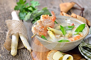 Cream of asparagus soup with prawns