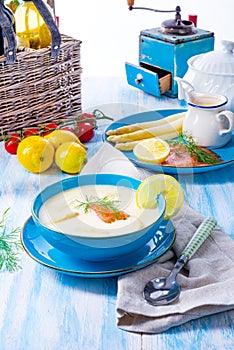 Cream of asparagus soup with salmon rolls and dill