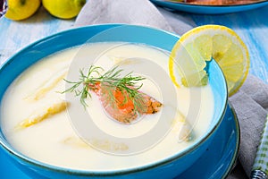 Cream of asparagus soup with salmon rolls and dill