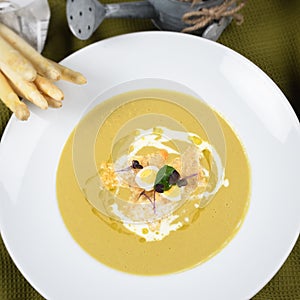 Cream of asparagus soup is a soup prepared with asparagus,stock and milk or cream as ingredients