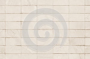 Cream or beige tiles ceramic wall and floor, marble abstract background. Design geometric mosaic texture decoration of the bedroom