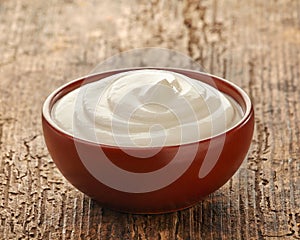 Cream in a brown ceramic bowl