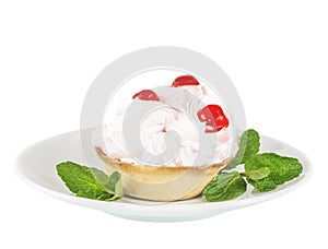 Cream cake with cherry on a white saucer