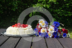Cream cake and summer flowers