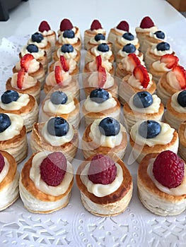 Cream cakes with red berries photo