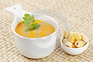 Cream of carrot soup and bread croutons photo