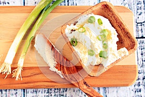 cream cheese and chives in wooden bowl