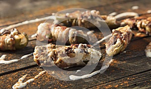Cream Cheese Filled Bacon Wrapped Jalapeno Poppers On Wood Background