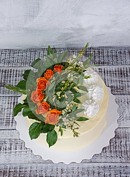 Cream cheese vanilla wedding cake with orange roses