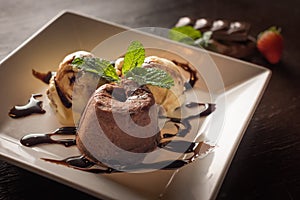 cream and chocolate ice cream dessert on white square plate.