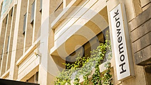 Cream Color Building with a Homewrok Terrace Sign Next to the Entrance