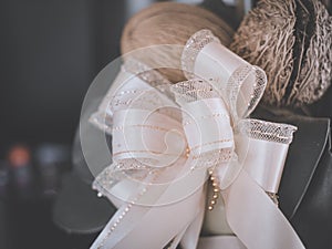 Cream colored bow tied with a gift To be congratulated