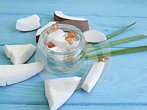 Cream cosmetic coconut on blue wooden capsule