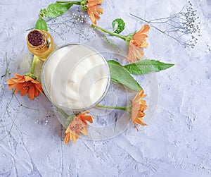 Cream cosmetic oil flower calendula healthy relaxation accessories handmade on concrete background