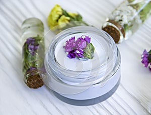 Cream cosmetic, wild flowers plant , organic product freshness moisturizer essence vintage on a wooden background