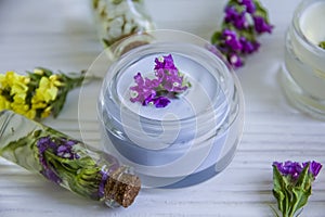 Cream cosmetic, wild flowers plant , organic freshness moisturizer essence vintage on a wooden background