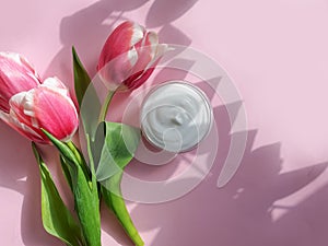 Cream cosmetics flower aroma product   tulip on colored background