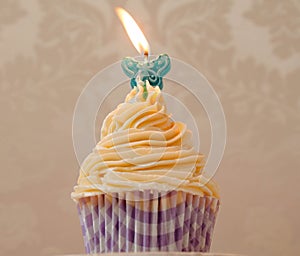 Cream cupcake with candle photo