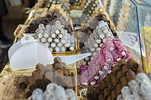 Cream-filled Pastries Decorated with Colorful Pralines inside the Exhibitors in a Pastry Shop