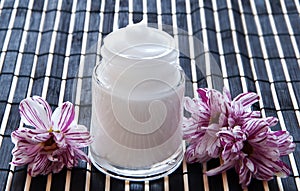 Cream and flower on a bamboo