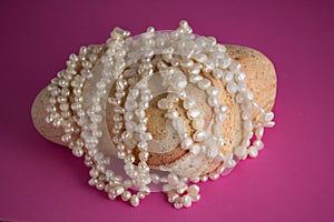Cream freshwater pearl strings on rock