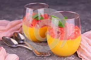 Cream Kurd from grapefruit in a glass on a gray background. Close-up. photo