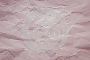 Cream paper background. Pastel, soft pink color. Vintage texture of creased sheet. Painted crumpled page, pattern. Copy space. Lig