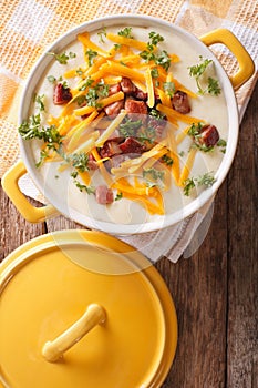 cream potato soup with bacon and cheddar cheese close-up. Vertical top view