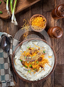 Cream of potato soup with bacon, cheese and green onions