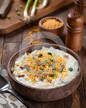 Cream of potato soup with bacon, cheese and green onions