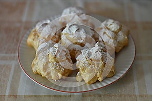 Cream puffs filled sprinkled with powdered sugar