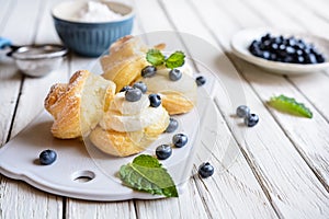 Cream puffs filled with vanilla cream and blueberries