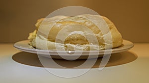 Cream roll on a plate white shadow background.