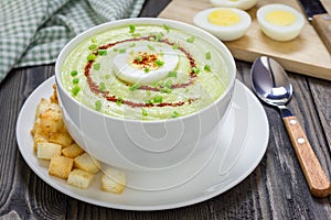 Cream soup with avocado, garnished with egg and croutons. Healthy eating.