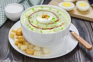 Cream soup with avocado, garnished with egg and croutons