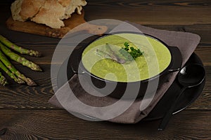 Cream soup, green asparagus, on a wooden background, healthy food, horizontal, no people,