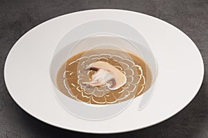 Cream soup with mushrooms in a white plate