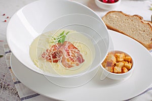 Cream soup with parmesan and bacon and crackers