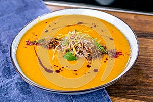 Cream soup of root vegetables with duck. European cuisine. The work of a professional chef. Dish from a restaurant or cafe menu.