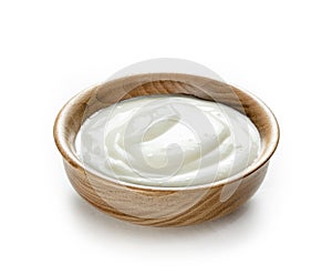 Cream sour in small wooden bowl  isolated white background photo