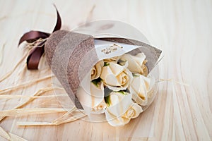 CREAM white roses flowers with valentine festival gift and beautiful blur bouquet and love word on the bouquet. flower on the wood
