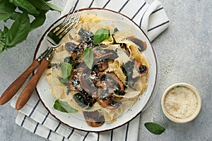 Creamy Alfredo pasta. Italian pasta fettuccini with mushrooms, chicken meat, spinach, basil and cream sauce on grey stone