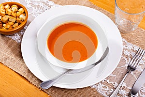 Creamy carrot soup garnished with crispy toasted bread