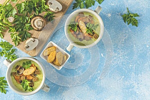 Creamy cauliflower soup with toasted bread croutons on blue tabletop. Vegetarian healthy food concept. Ideas and recipes for