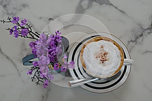 Creamy coffee on a marble-patterned table